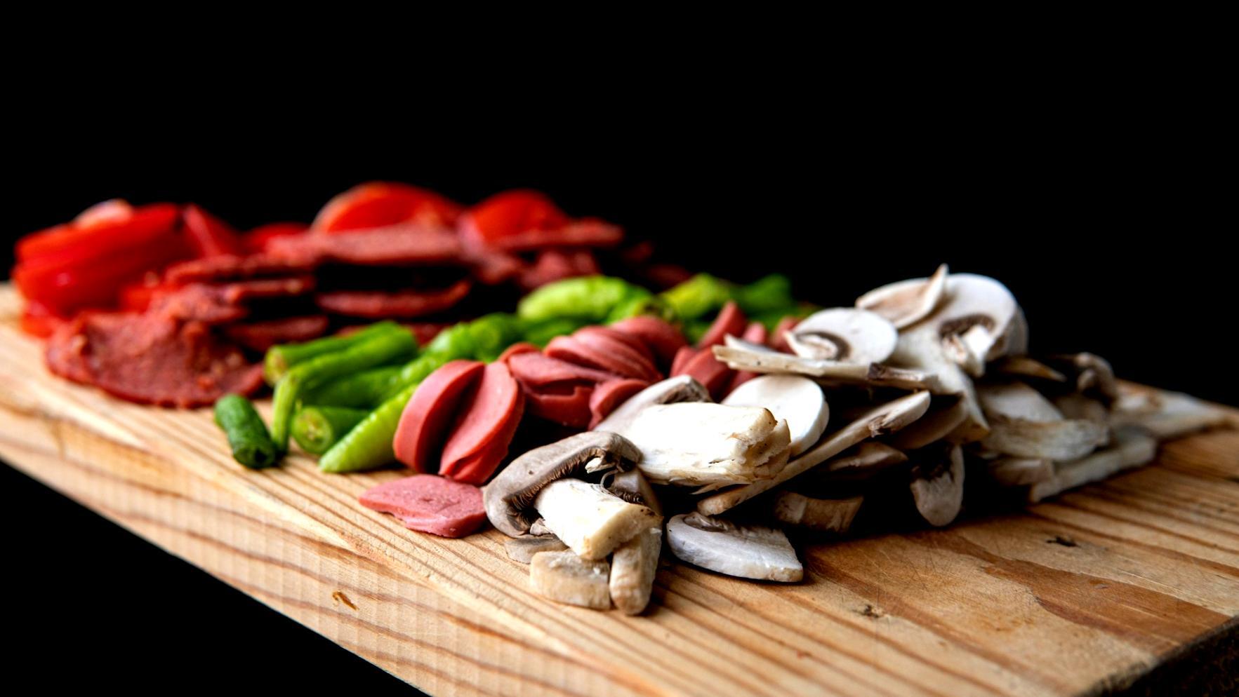 Professional kitchen workspace showing traditional cooking techniques